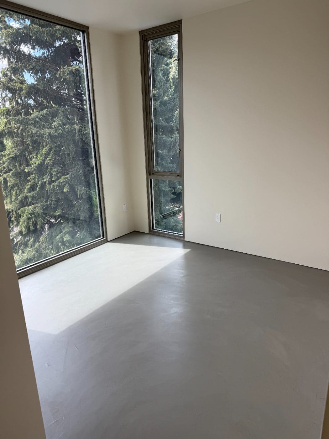 Continuous microcement floor across an open-plan great room