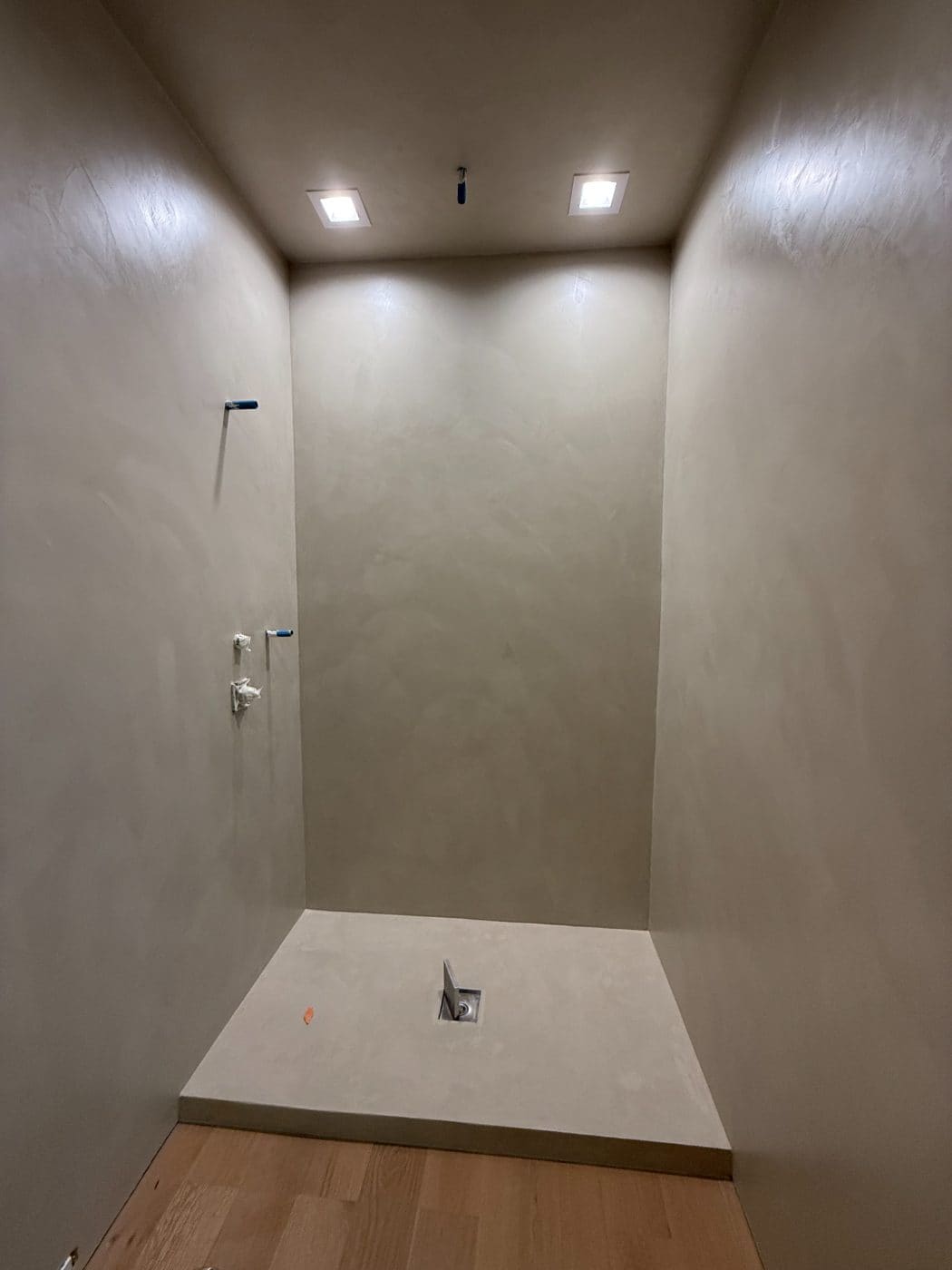 Waterproofed microcement shower pan and walls